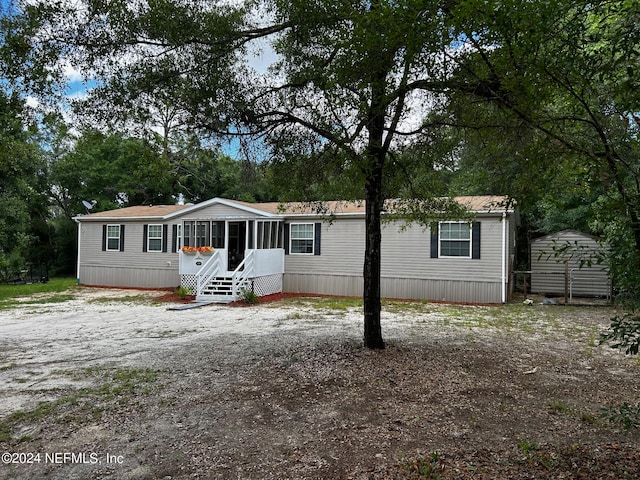 view of front of home featuring a storage unit