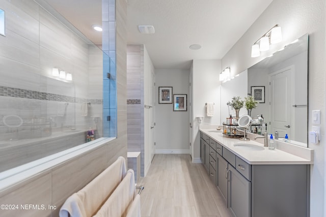 bathroom with dual sinks and vanity with extensive cabinet space