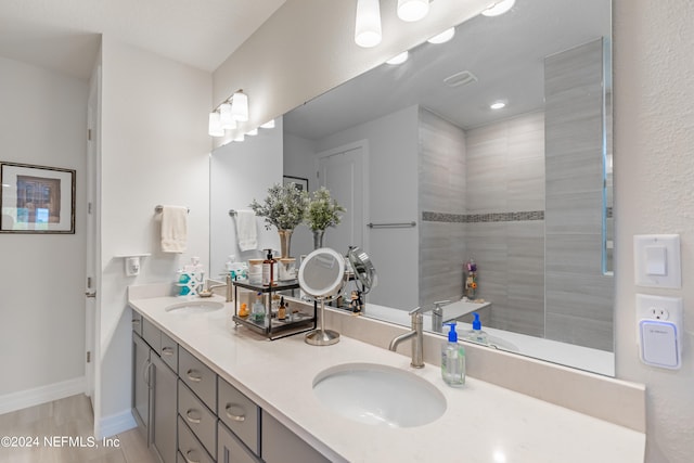 bathroom with dual sinks and oversized vanity