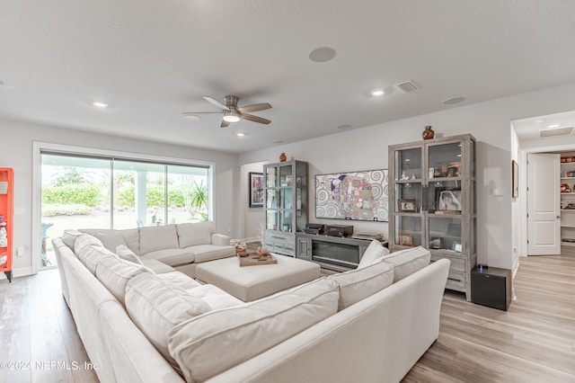 living room featuring ceiling fan and light hardwood / wood-style floors