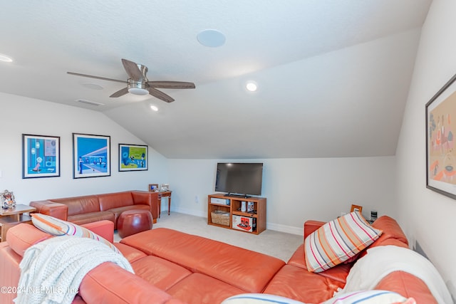 carpeted living room with ceiling fan and lofted ceiling