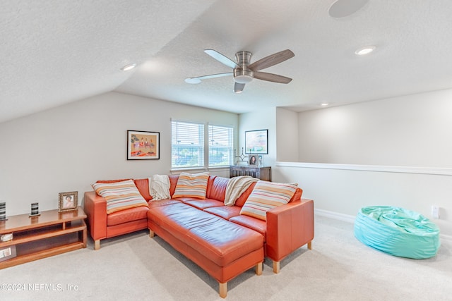 carpeted living room with ceiling fan, a textured ceiling, and vaulted ceiling