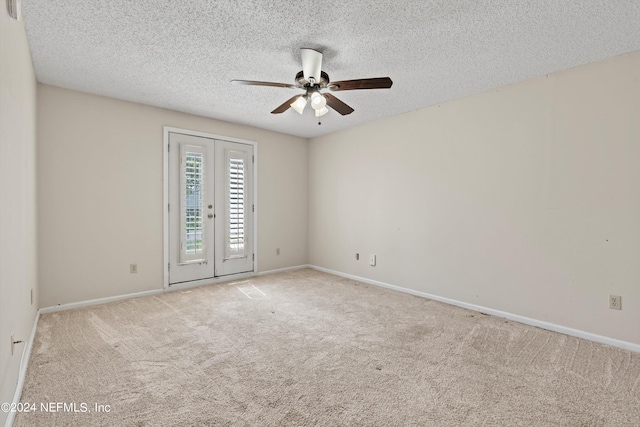 unfurnished room featuring french doors, light colored carpet, and a textured ceiling