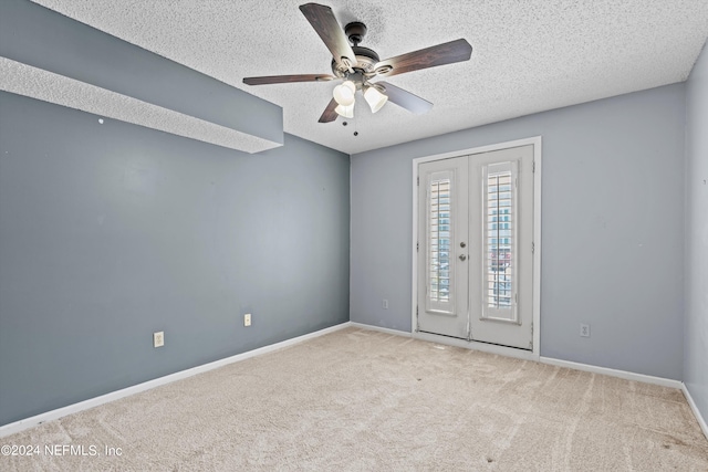 unfurnished room featuring light carpet, french doors, a textured ceiling, and ceiling fan