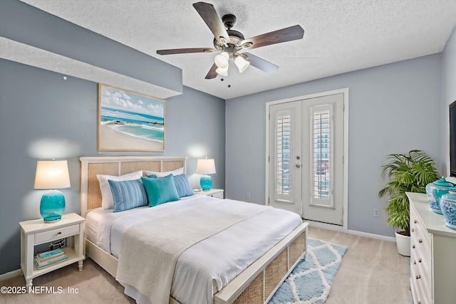 carpeted bedroom featuring access to exterior, ceiling fan, french doors, and a textured ceiling