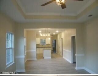 kitchen with a tray ceiling and ceiling fan