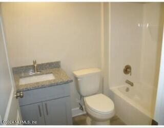 full bathroom with toilet, vanity, and tub / shower combination