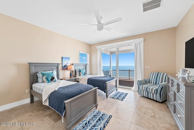 bedroom featuring ceiling fan, a fireplace, a water view, light tile floors, and access to outside