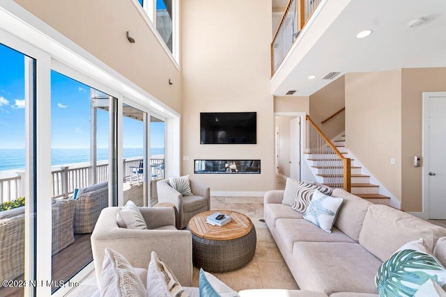 tiled living room featuring a water view