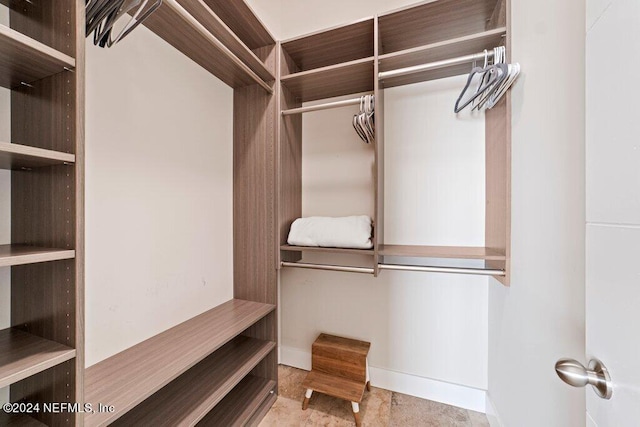 spacious closet featuring light tile floors