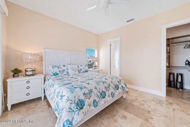 tiled bedroom featuring a spacious closet, a closet, and ceiling fan