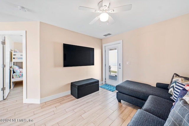 living room featuring ceiling fan and light wood-type flooring