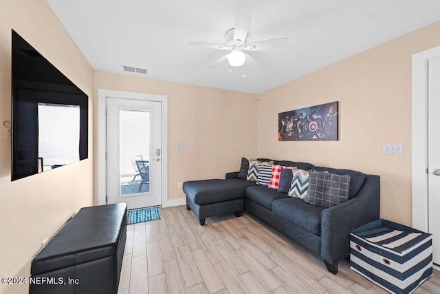 living room with ceiling fan and light wood-type flooring