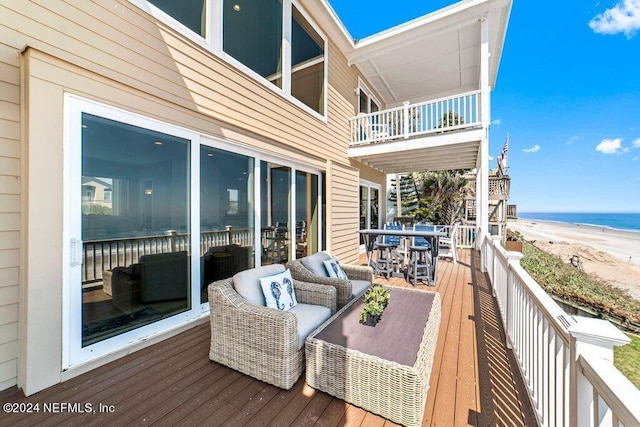 wooden deck featuring a water view and outdoor lounge area