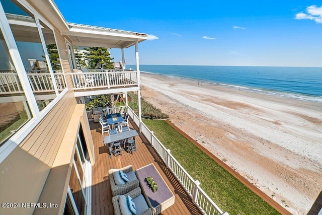 balcony with a beach view and a water view