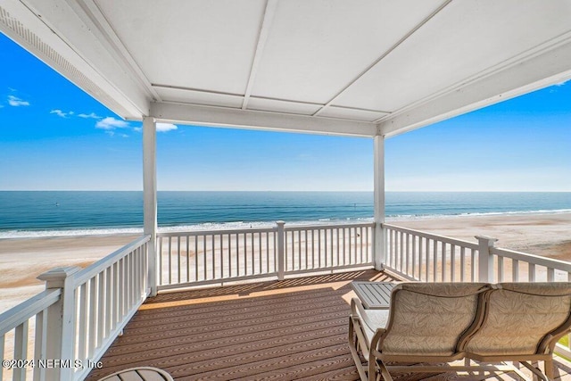 balcony with a water view and a beach view