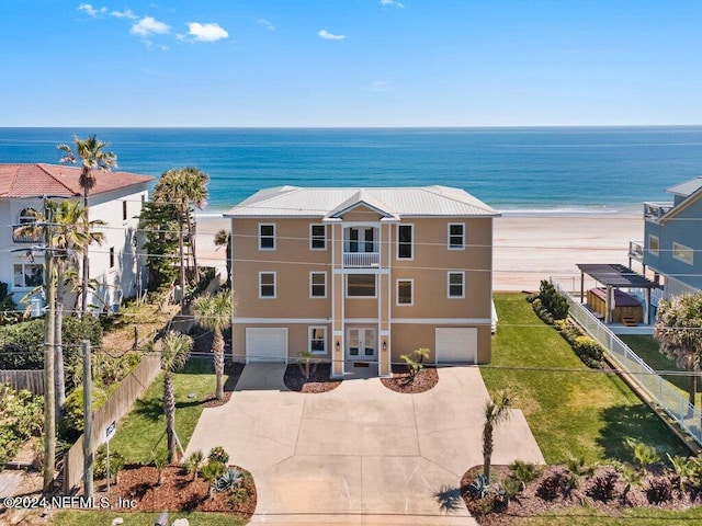 exterior space with a balcony, a water view, and a front yard