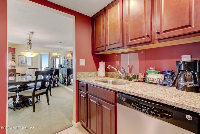 kitchen with light colored carpet, pendant lighting, sink, light stone counters, and dishwasher