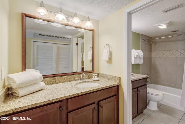 full bathroom with toilet, tiled shower / bath combo, a textured ceiling, vanity, and tile flooring