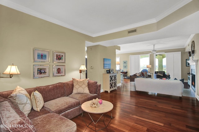 living room with ceiling fan, dark hardwood / wood-style flooring, and ornamental molding