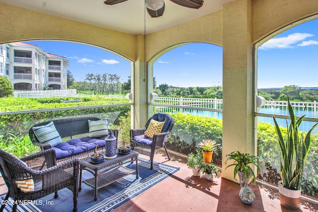 view of patio / terrace with an outdoor living space, a water view, and ceiling fan