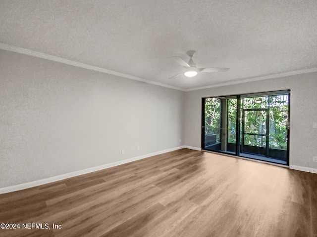 empty room with hardwood / wood-style floors, a textured ceiling, crown molding, and ceiling fan