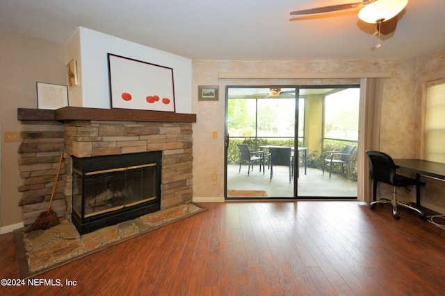 living room with dark hardwood / wood-style floors, a fireplace, and ceiling fan