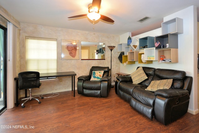 living room with ceiling fan and dark hardwood / wood-style flooring