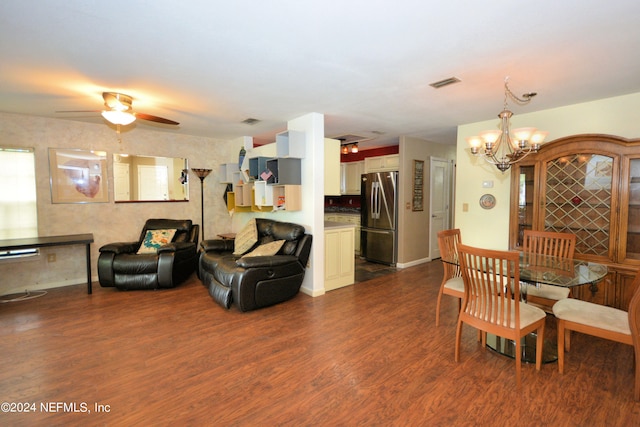 interior space featuring ceiling fan with notable chandelier and dark wood-type flooring