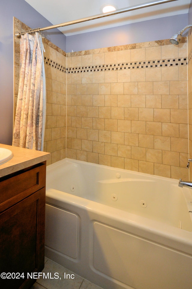 bathroom with shower / bath combo with shower curtain, tile floors, and vanity