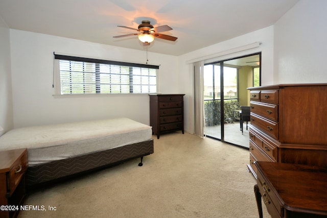 bedroom with light colored carpet, ceiling fan, and access to exterior