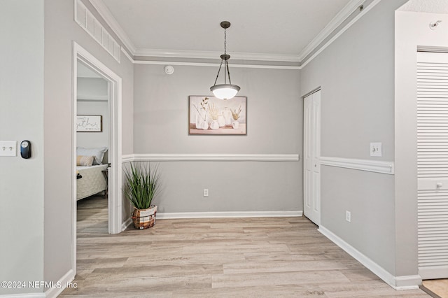 interior space with crown molding and light wood-type flooring