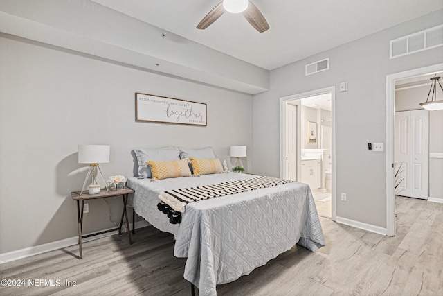 bedroom with ensuite bath, light hardwood / wood-style floors, and ceiling fan