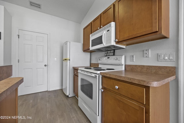 kitchen with light hardwood / wood-style flooring and white appliances