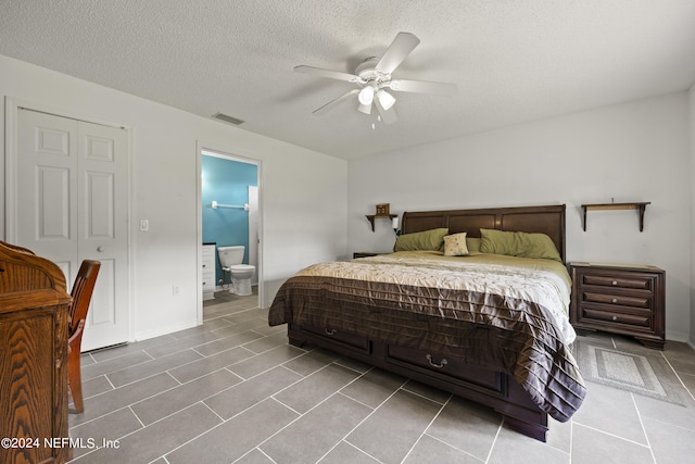 tiled bedroom with connected bathroom, a closet, ceiling fan, and a textured ceiling