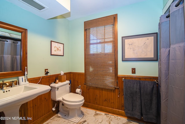 bathroom featuring sink, tile flooring, and toilet