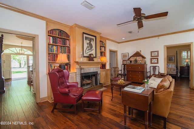 living room with plenty of natural light, dark hardwood / wood-style floors, ceiling fan, and a brick fireplace