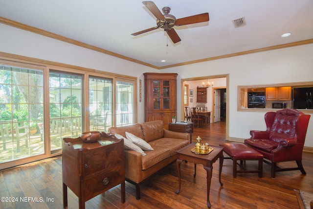 living room with crown molding, dark hardwood / wood-style floors, and ceiling fan