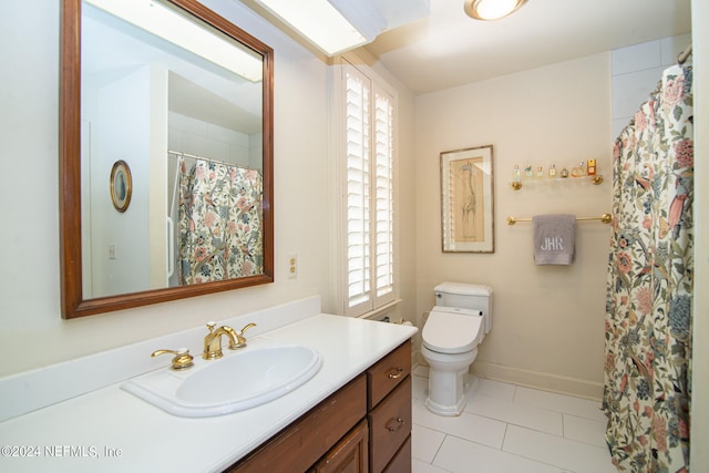 bathroom with vanity, tile flooring, and toilet