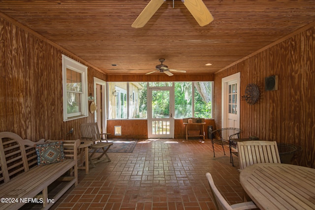 sunroom with ceiling fan and wooden ceiling