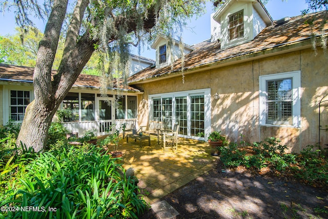 back of property with a patio