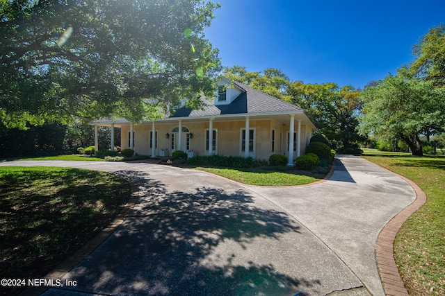 view of front of house with covered porch and a front yard