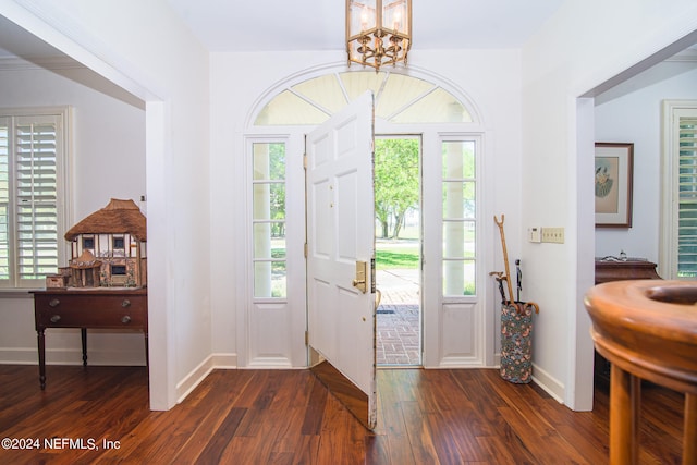 entrance foyer featuring dark hardwood / wood-style floors and an inviting chandelier