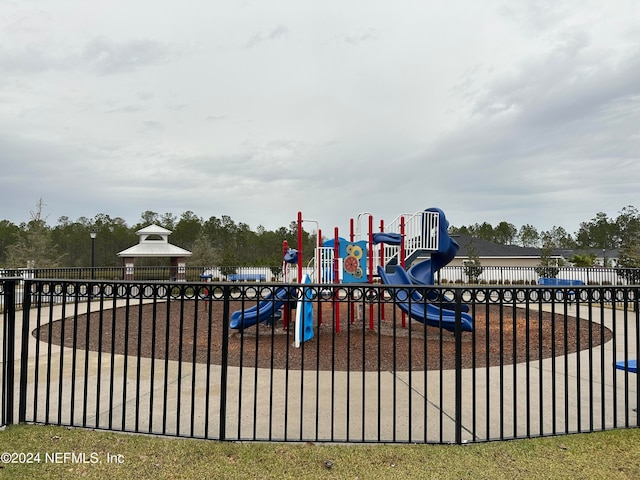 community jungle gym featuring fence