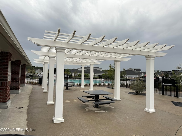 view of patio / terrace with fence and a pergola