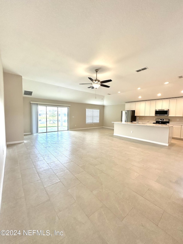 unfurnished living room with ceiling fan, visible vents, baseboards, and recessed lighting