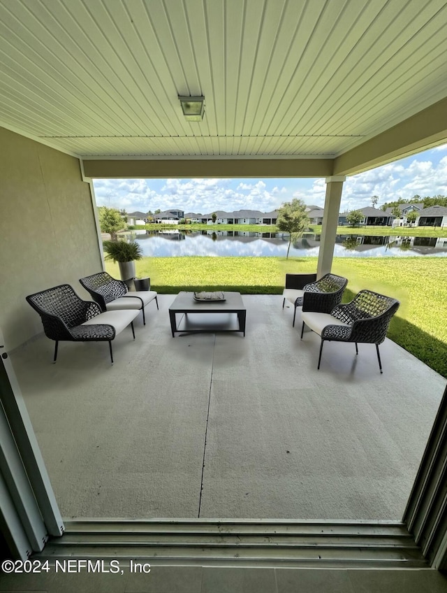 view of patio featuring a water view and an outdoor hangout area