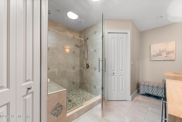 bathroom featuring a tile shower and tile flooring