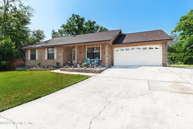 ranch-style home with a front lawn and a garage