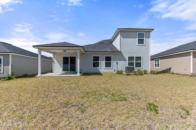 rear view of house with a yard, central AC, and a patio